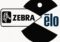 A black Pac-Man shape faces right, appearing to eat two logos: one saying ZEBRA with a zebra head icon, and the other saying ēlo with a macron over the e—symbolizing the recent news that Zebra buys Elo Touch. The background is white.