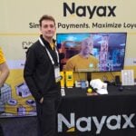 Paul Drutch highlights the VPOS reader at the Nayax Ltd. exhibit.