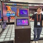 Nathan Hawthorne introduces the interactive gaming floor at the Pixel Games exhibit.
