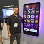 Cameron Fleming introduces the new, still-to-be named, flagship jukebox at the TouchTunes exhibit.