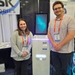 Emily Cole and Corbin Climer show the OmniKiosk at the Innovative Kiosk Technologies exhibit.